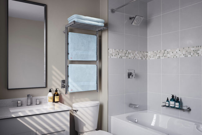 Setting of EDGE 10 Bar 20 inch heated towel rack in small bathroom above toilet