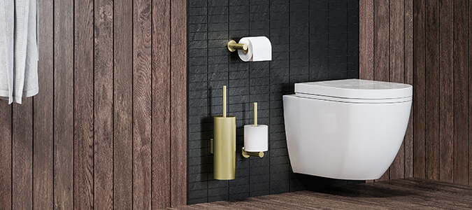 Paper holder and spare paper holder around wall hung toilet with toilet brush in champagne gold